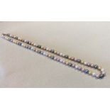 A row of multicoloured cultured pearls of natural colour,