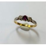 A three stone ruby and diamond ring,