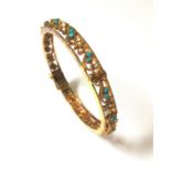 A turquoise and pearl set filigree bangle,