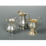 Two George II silver cream jugs together with a George III example,