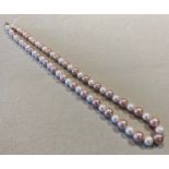 A row of candy pink and white Edison Freshwater cultured pearls of exceptional size,