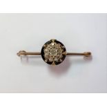 A diamond cluster and black enamel bar brooch,