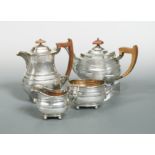 A George VI silver three piece tea set with one addition,
