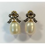 A pair of cultured pearl and diamond bow earpendants,