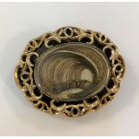 An early Victorian hairwork and black enamel mourning brooch,