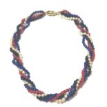 A torsade of lapis lazuli, coral, cultured pearl and onyx beads,