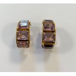 A pair of amethyst set hoop style ear clips,