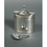 A George V silver tea caddy and caddy spoon,