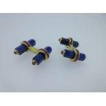 A pair of baton cufflinks each set with lapis lazuli and rubies,
