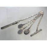 An Edward VII silver chatelaine with four attachments and one addition,
