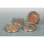 Four probably late 18th Century German metalwares wine coasters,