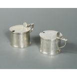 A near pair of Victorian silver drum mustards,