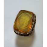 A dress ring with a carved citrine Intaglio,