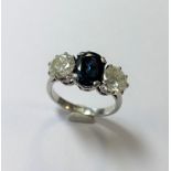 An impressive sapphire and diamond three stone ring,