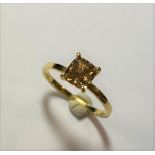 A single stone ring set with a natural fancy coloured diamond,