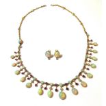 An opal and ruby fringe necklace with opal earstuds en suite,