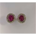 A pair of ruby and diamond earstuds,