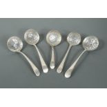 A George II silver sugar sifting spoon together with four early George III silver examples,