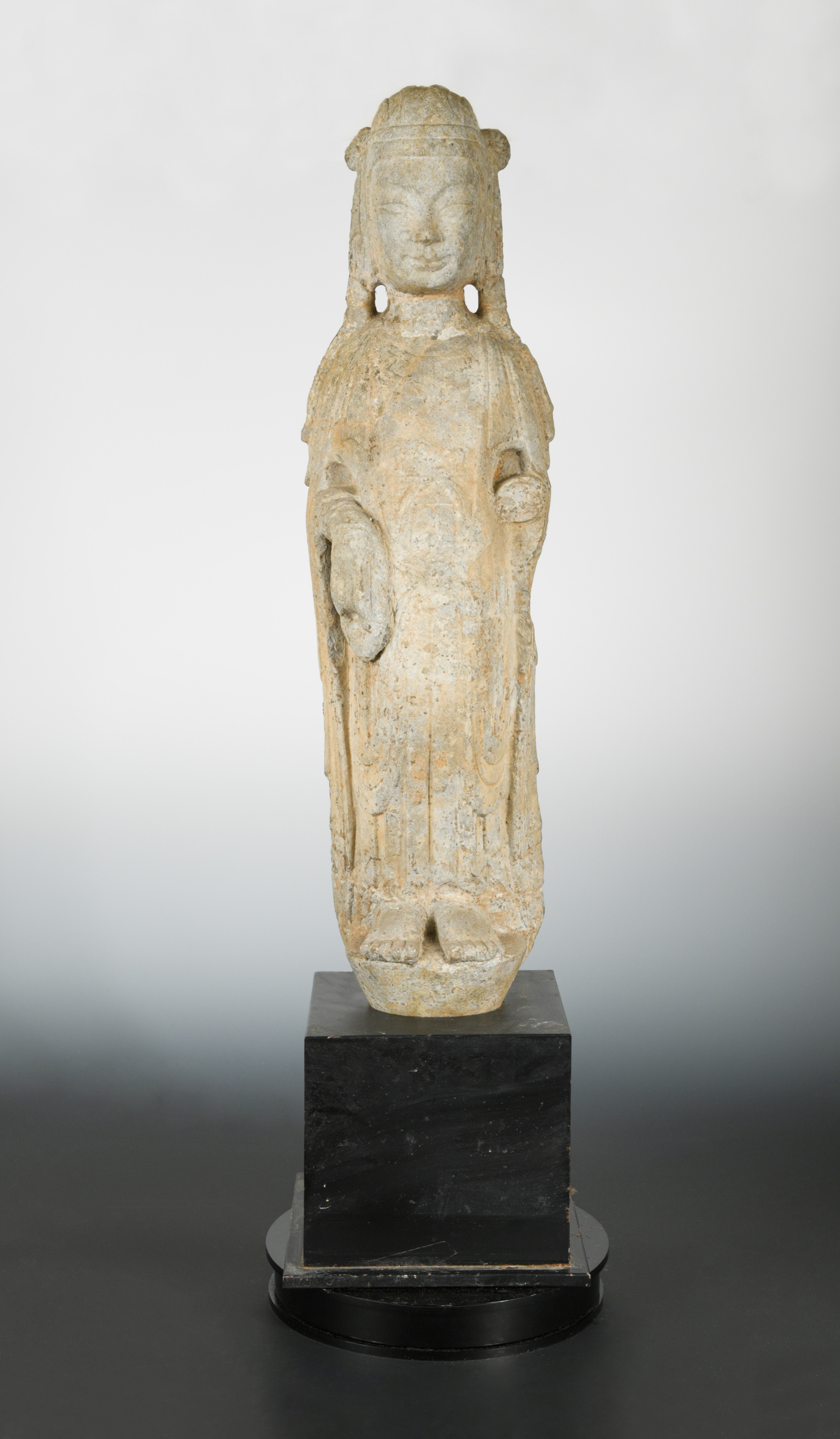 A Chinese grey stone standing figure of Guanyin, in Sui Dynasty style,