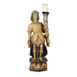 A carved and polychrome decorated limewood figure of a torch bearer, 18th century,