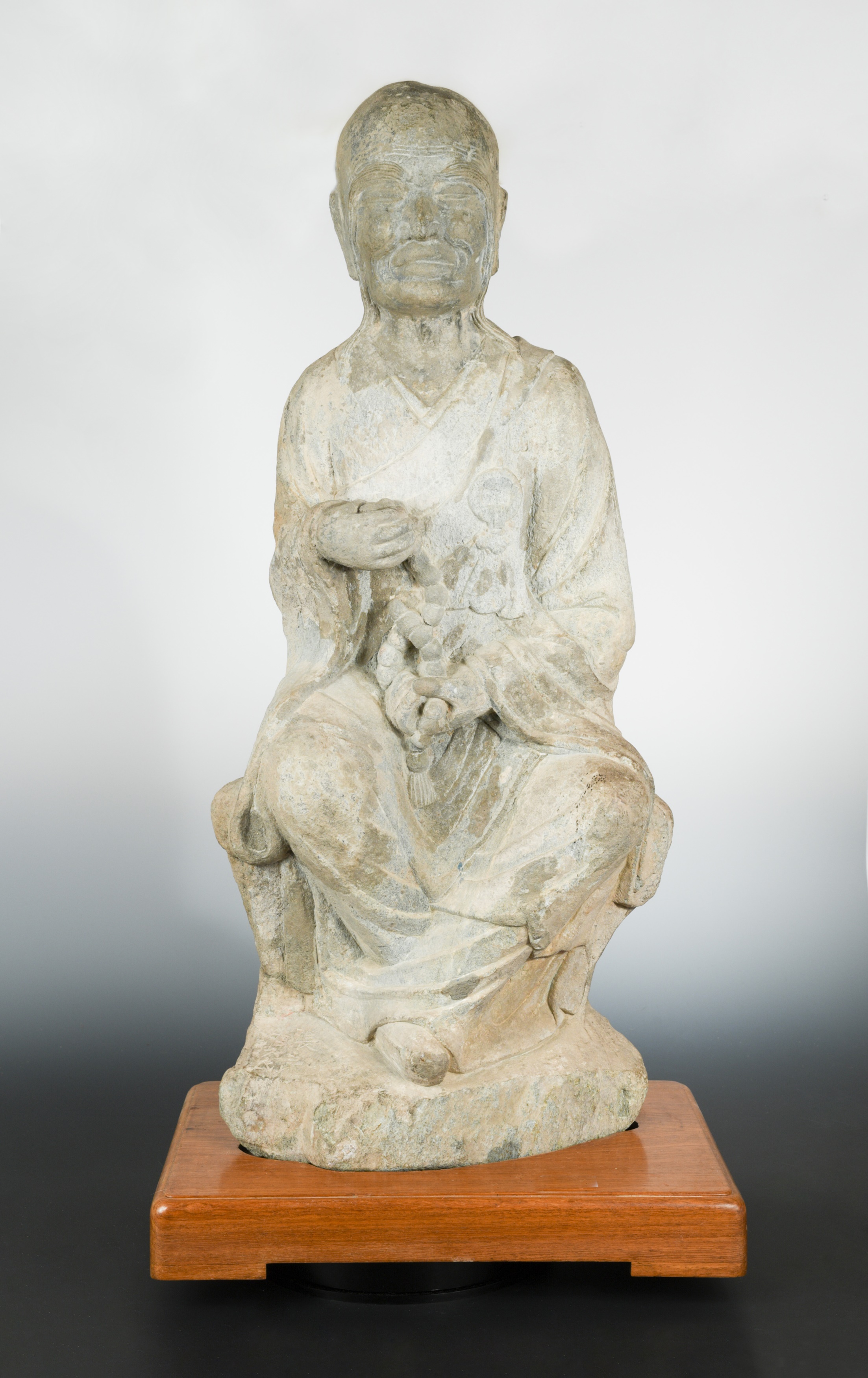 A Chinese stone seated Arhat, perhaps Tang Dynasty (618 AD - 907 AD),