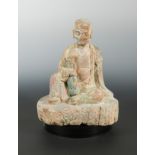 A Chinese carved and polychrome wood figure of Iohan, in Yuan/early Ming style,