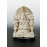 A Chinese grey stone Buddhist triad stele with aureole, in Wei Dynasty style,