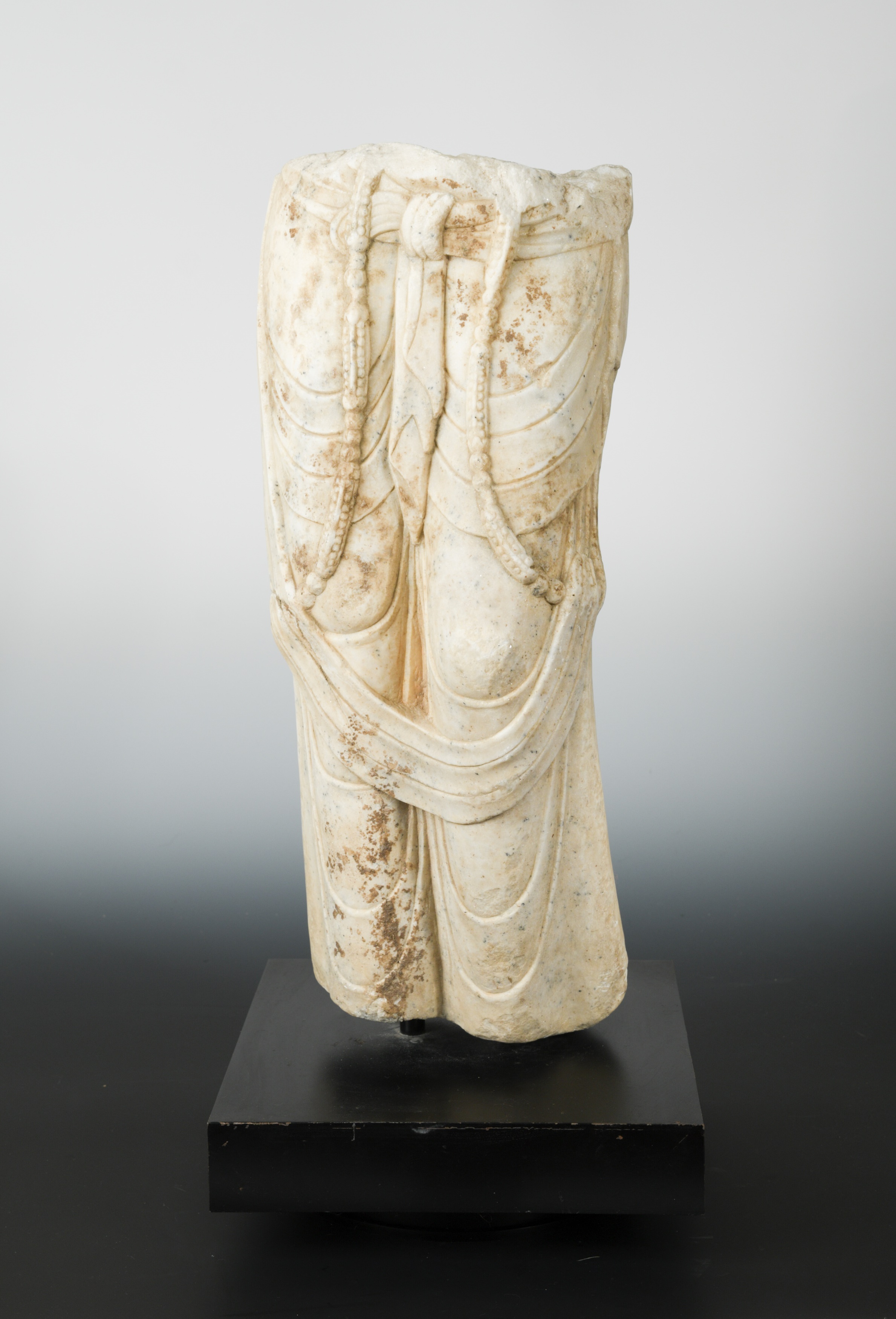 A white marble figure of Avalokiteshvara, lower body only, in Tang Dynasty style,