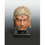 A painted stucco head of Buddha, perhaps Jin Dynasty (1115 A.D - 1234 A.D),