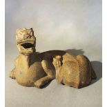A Chinese grey limestone figure of a recumbent Pixiu/Chimera, in Southern Qi style,