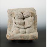 A Chinese carved greystone group of a Chinese couple in loving embrace,