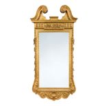A giltwood and gesso wall mirror in the manner of William Kent,