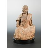 A Chinese carved & polychrome wood figure of a seated dignitary or immortal,