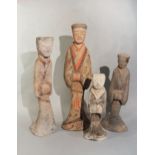 A group of four Chinese painted pottery standing male and female attendants, perhaps Han Dynasty,