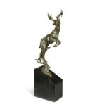 A contemporary bronze model of a leaping stag,
