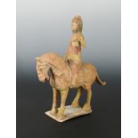 A Chinese painted pottery horse with Middle Eastern lady rider up, in Tang Style,