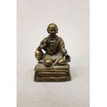 A Sino-Tibetan Silvered bronze small seated figure of a Monk, circa 1800,