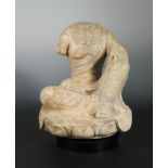 A Chinese white marble figure of a seated Buddhist deity, headless, in early Sui Dynasty style,