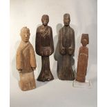 A group of four Chinese carved and painted wood standing figures, in Han Dynasty style,