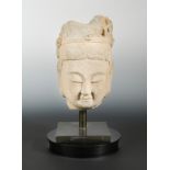 A Chinese sandstone head of a crowned Buddha, in Tang Dynasty style,