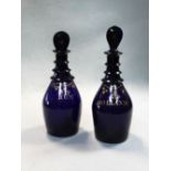 A pair of 19th century Bristol Blue triple neck decanters and stoppers,