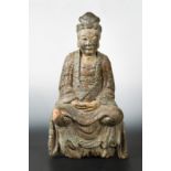 A Chinese carved and polychrome wood seated figure of Guanyin, perhaps late Ming Dynasty,