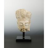 A Chinese limestone head of Avalokiteshvara, perhaps Sui Dynasty (581-618 AD),
