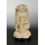 A Chinese sandstone figure of a seated Monk, in Tang Dynasty Style