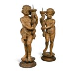 A pair of carved limewood pricket stands, probably 17th century,
