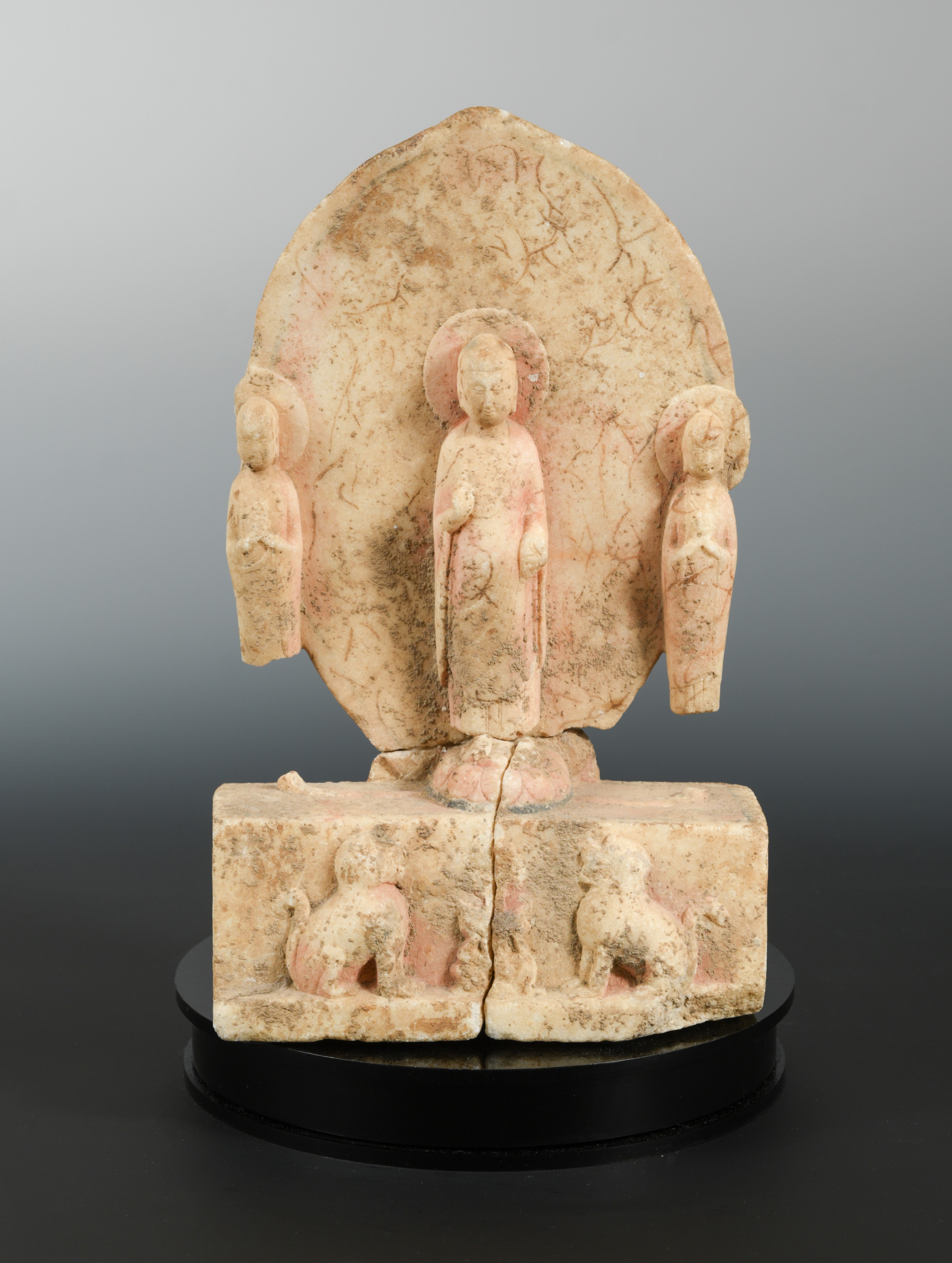 A Chinese white marble Buddhist triad group, in Northern/Eastern Wei style,