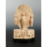 A Chinese white marble Buddhist triad group, in Northern/Eastern Wei style,