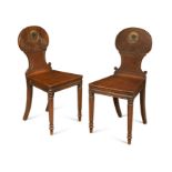 A pair of Regency oak hall chairs,