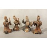 A group of four Chinese painted pottery seated musicians, perhaps Tang Dynasty,