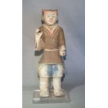 A Chinese painted pottery, standing figure of a guard or attendant, perhaps Han Dynasty,